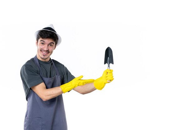 Front view male gardener holding little spatula on white background ground tree flower work bush grass job color garden