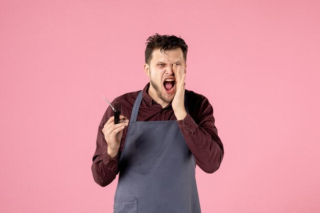 front view male hairdresser with hairbrush and scissors screaming on pink background