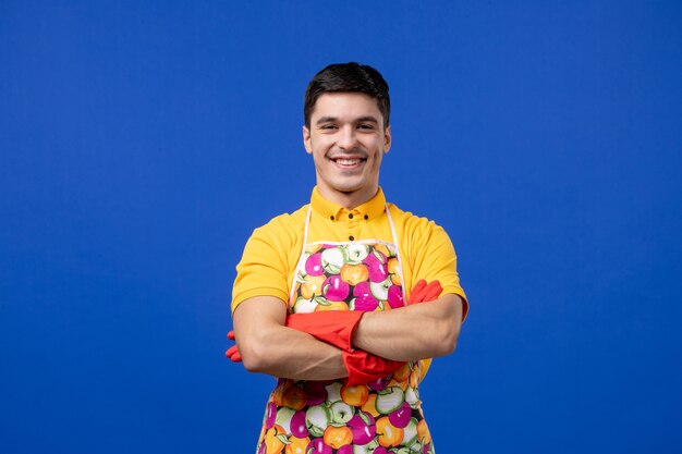 Front view male housekeeper in apron crossing hands 