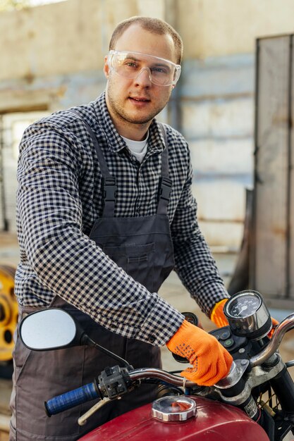 Front view of male mechanic with protective glasses