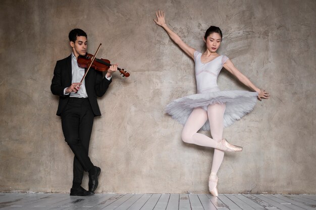 Front view of male musician with violin and ballerina