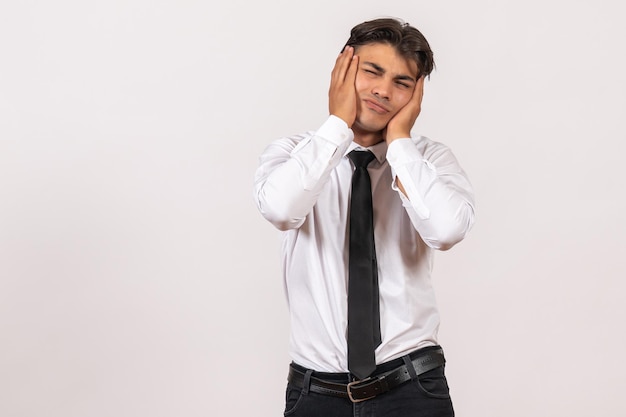 Front view male office worker just standing on a white wall human office work job male