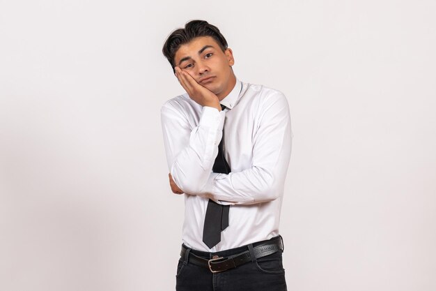 Front view male office worker posing on a light white wall work male job business