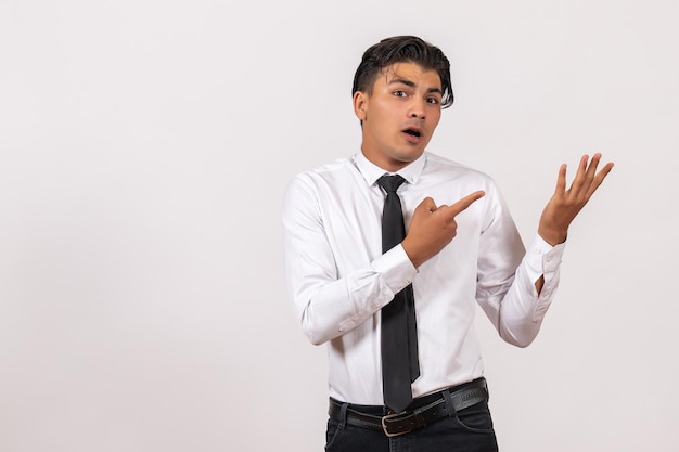 Front view male office worker posing on white wall work male job business