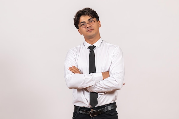 Front view male office worker posing on white wall work office human job