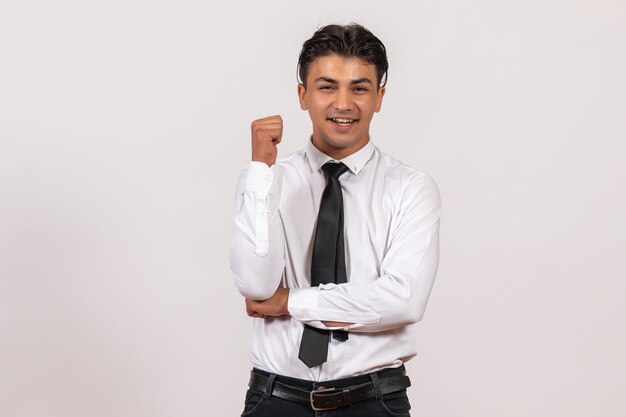 Front view male office worker smiling on white wall work male job business