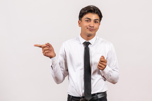 Front view male office worker standing on a white wall human office work job male