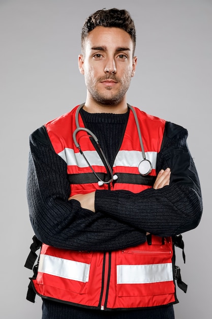 Front view of male paramedic with crossed arms