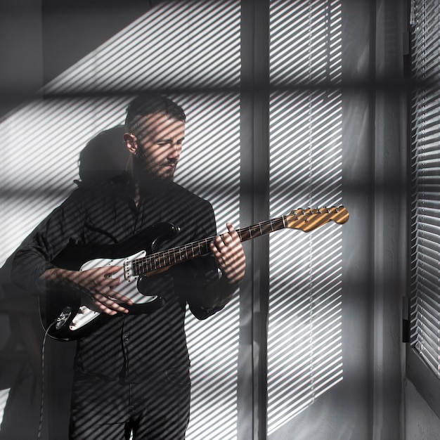 Front view of male performer playing electric guitar