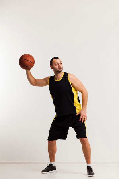 Front view of male player preparing to throw basketball