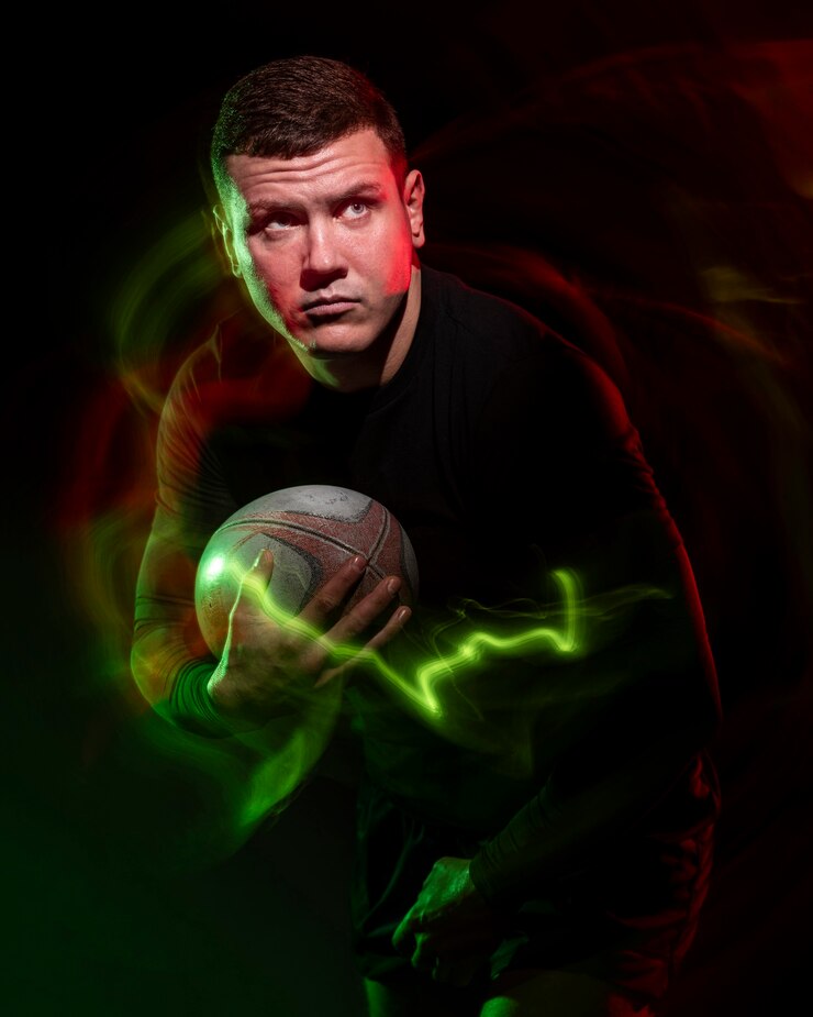 Free Photo front view of male rugby player holding ball with color effect