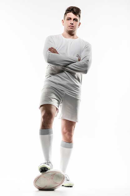 Free photo front view of male rugby player posing with ball and arms crossed