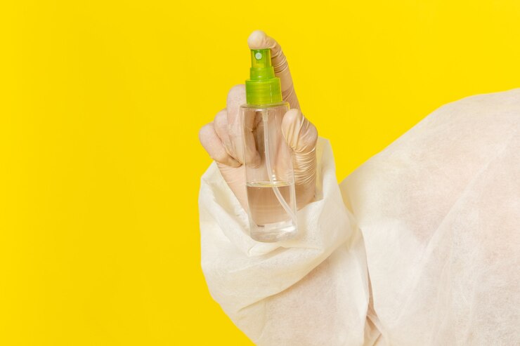 Free Photo front view male scientific worker in special protective suit holding spray on light-yellow surface