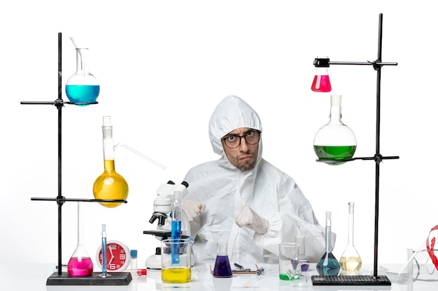 front view male scientist in special protective suit sitting angry