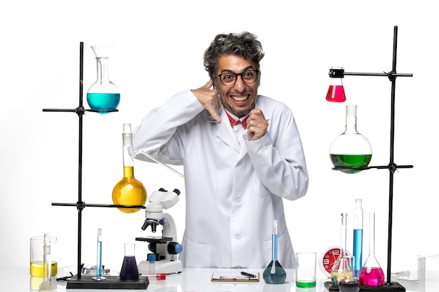 Front view male scientist in white medical suit standing and posing