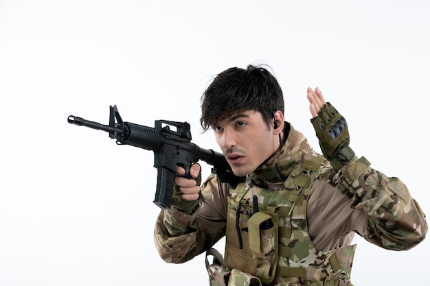 Free photo front view male soldier fighting during war with machine gun white wall