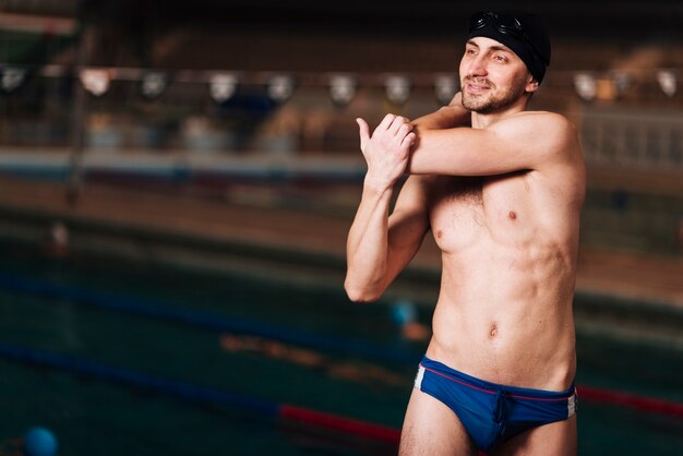 Front view male swimmer stretching