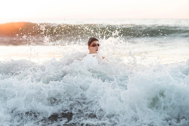 Front view of male swimmer swimming in the ocean