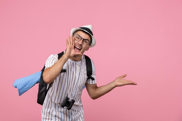 Front view male tourist screaming on pink wall emotion tourist color