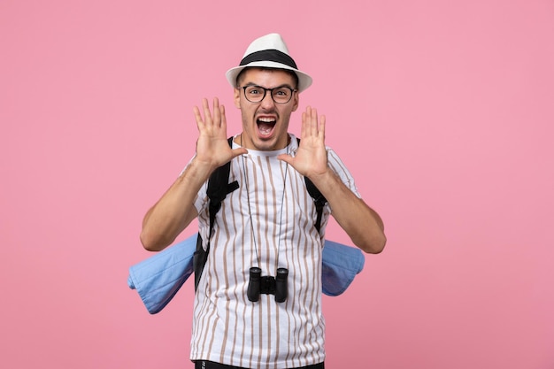 Free photo front view male tourist with his backpack on pink wall color emotions tourist