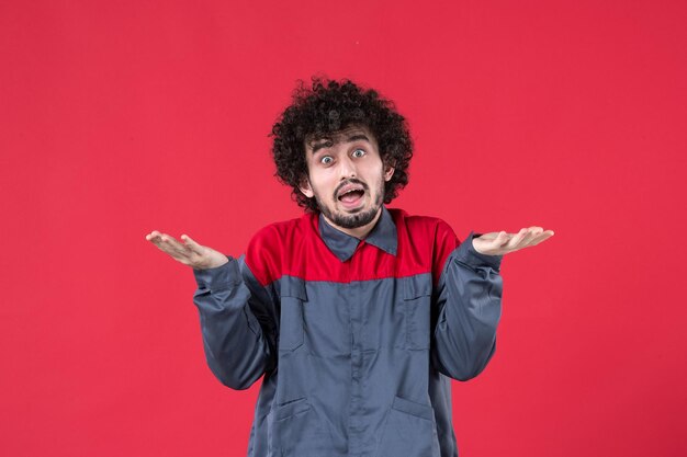 Front view male worker in uniform on red background mechanic photo house color job worker uniform tool instrument