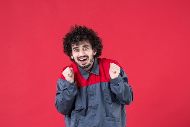 Front view male worker in uniform on red