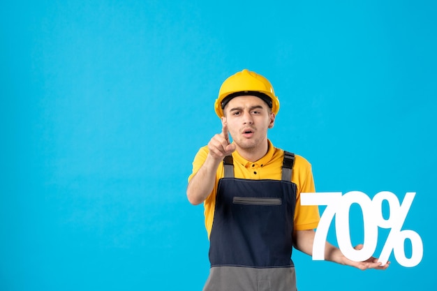 Front view of male worker in uniform with writing on blue 