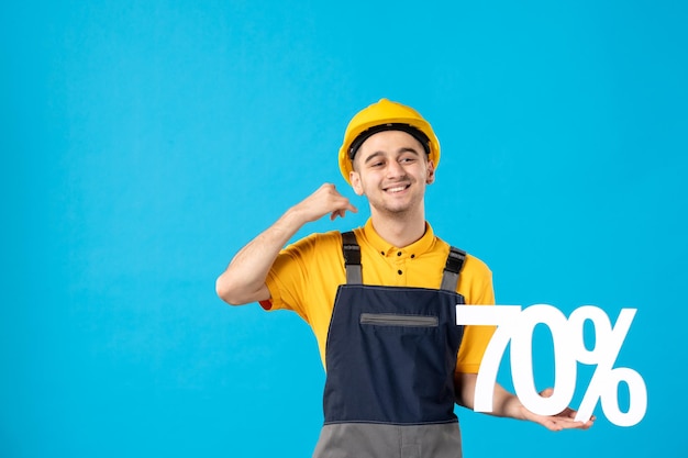 Front view of male worker in uniform with writing on blue 