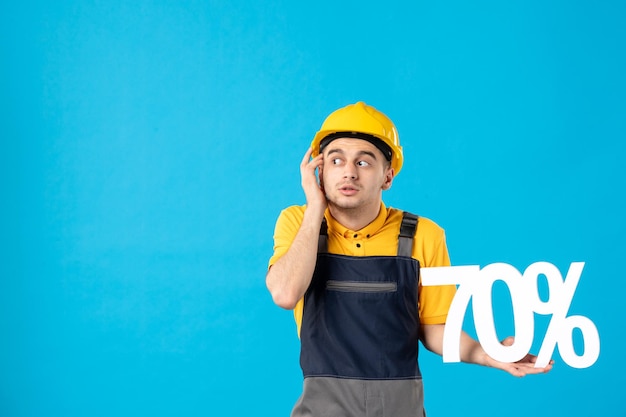 Front view of male worker in uniform with writing on blue 