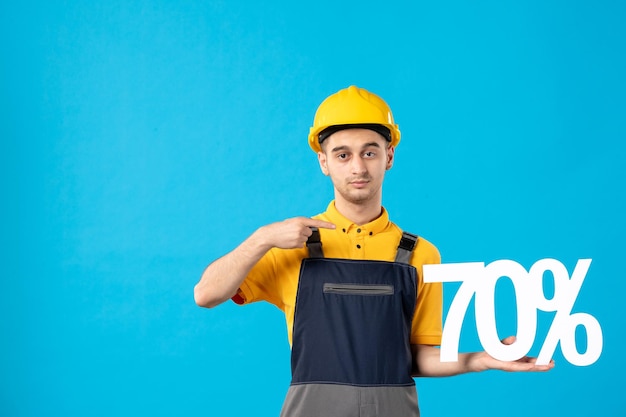 Front view of male worker in uniform with writing on blue 