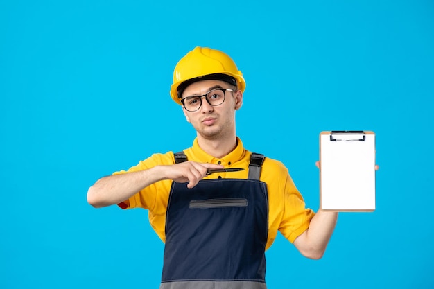 Front view of male worker in yellow uniform on blue 