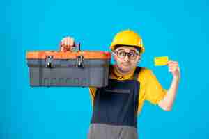 Free photo front view of male worker in yellow uniform with tool box on blue