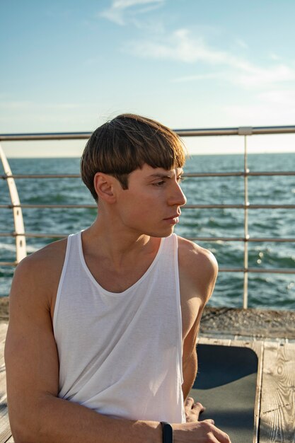 Front view of man at the beach in tank top