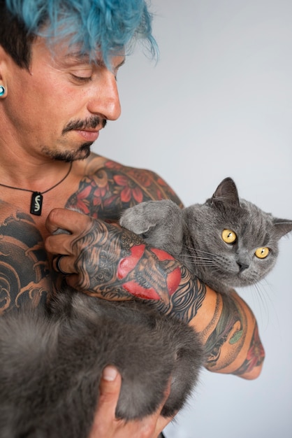 Free photo front view man being affectionate with cat