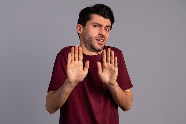 Free photo front view of man being disgusted and keeping distance