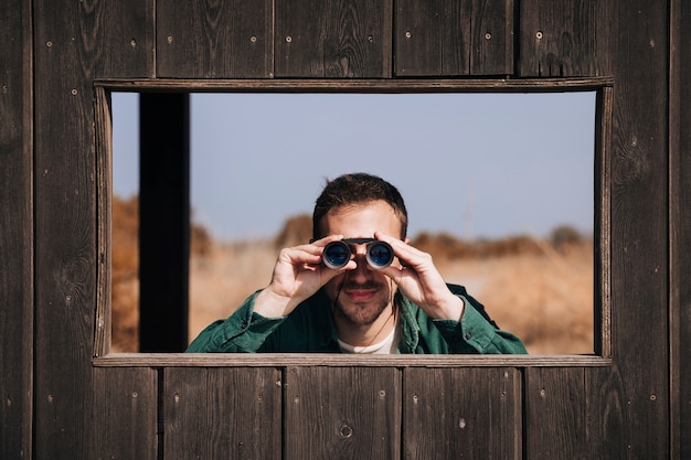 Free photo front view man bird watching