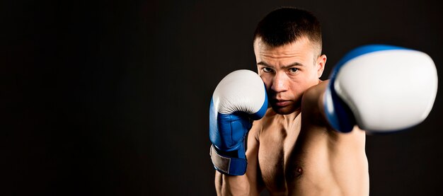 Front view of man boxing with copy space