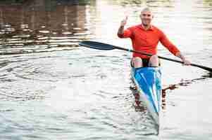 Free photo front view man in canoe showing approval