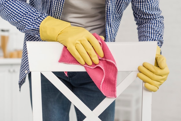 Free photo front view of man cleaning a chair