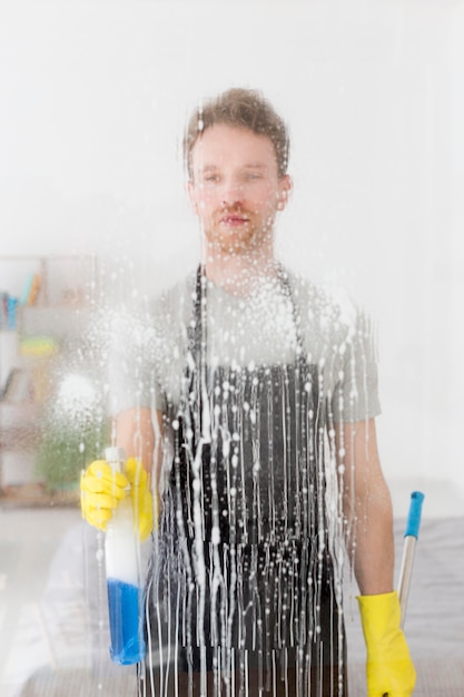 Front view man cleaning window