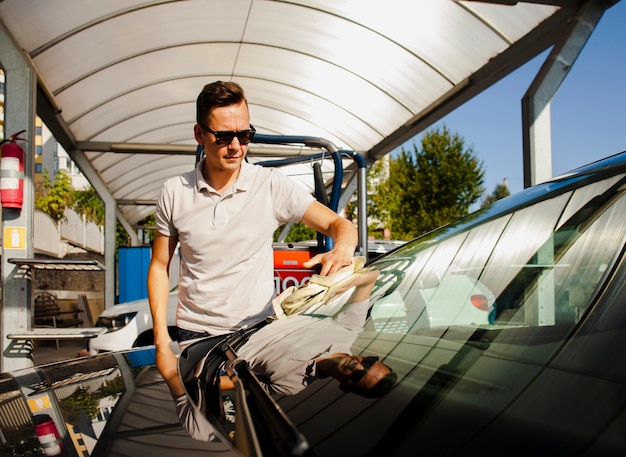 Front view man cleaning windscreen