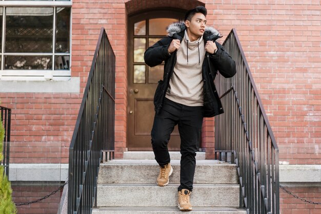 Front view of man coming down the stairs