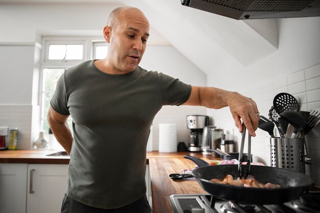 Front view man cooking at home