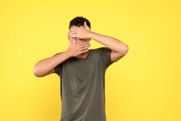 Front view of the man covered his face with his hands