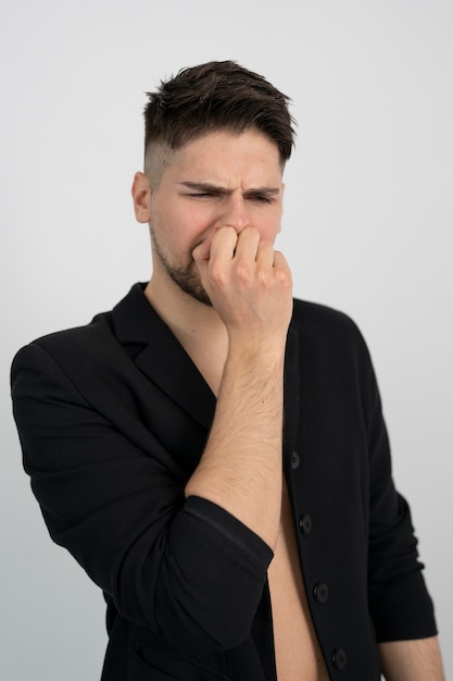 Front view man covering his mouth