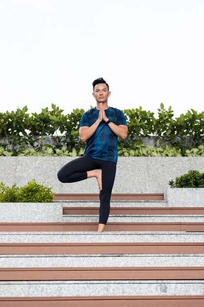 Front view of man doing yoga