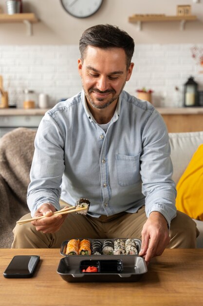 Front view man eating sushi