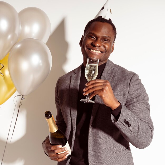 Front view man enjoying a glass of champagne