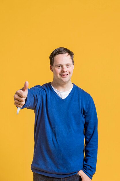 Front view of man giving thumbs up