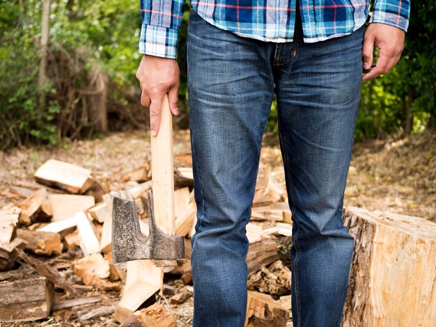 Front view man holding an axe